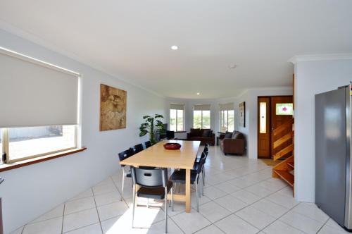 a dining room and living room with a table and chairs at Blue Holes Getaway - Kalbarri WA in Kalbarri