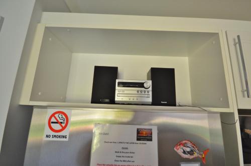 a shelf with two speakers and a radio on top of a refrigerator at Blue Ocean Villa 2 - Kalbarri WA in Kalbarri