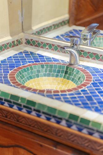 a bathroom sink with a mosaic counter top at Riad Tourtit in Imlil