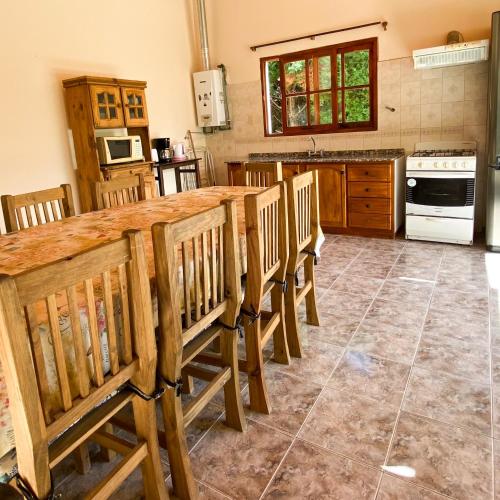 a kitchen with a large wooden table and chairs at Cabaña privada en Valle Grande San Rafael in Valle Grande