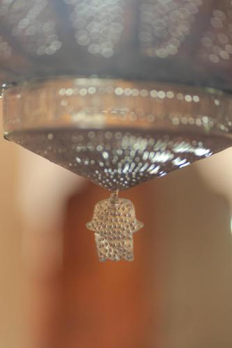 a bird charm hanging from a bird feeder at Riad Tourtit in Imlil