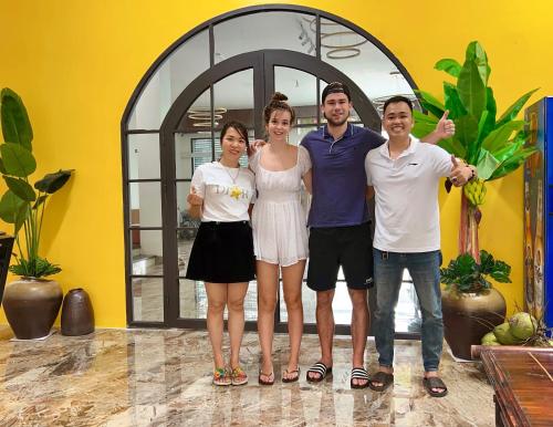 a group of people standing in front of a building at Phố Cổ Homestay in Kỳ Vĩ