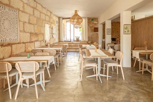 a restaurant with tables and chairs in a room at Agroturismo Can Pere Rei in Son Serra de Marina