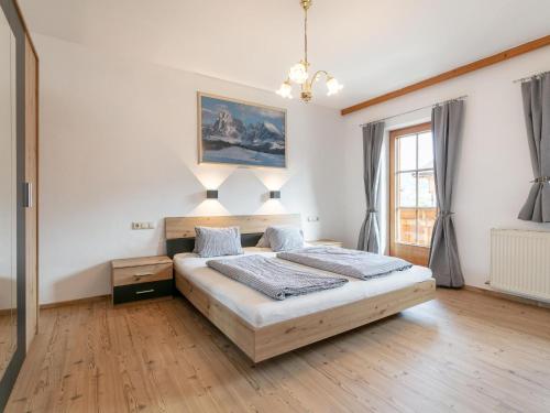 a bedroom with a bed and a painting on the wall at Bauernhof Seppen in Reith im Alpbachtal