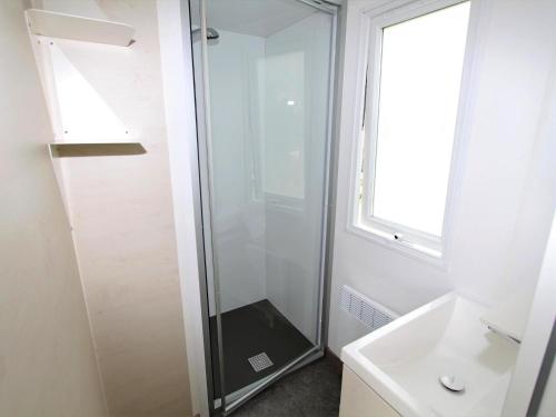 a bathroom with a shower and a sink at Mobile Home an der Drau in Sachsenburg