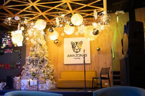 a christmas tree in a room with lights at Hotel Amazonas Suite, Suite Presidencial in Nueva Loja