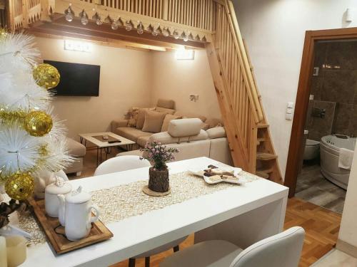 a kitchen and living room with a table and chairs at Zambak Apartments in Sarajevo
