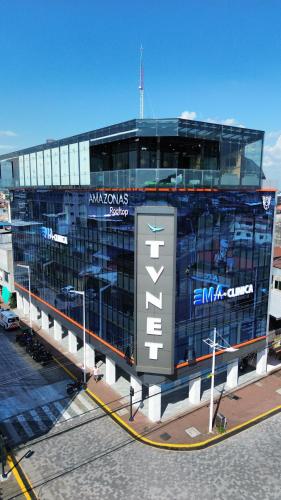 a building with a sign on the side of it at Hotel Amazonas Suite, Suite Presidencial in Nueva Loja
