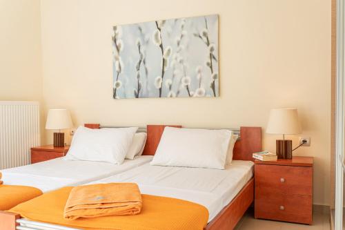 two beds in a room with two lamps at Arte Villa Nefeli Apartment in Sami
