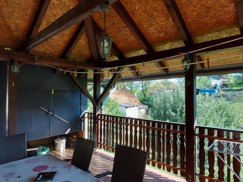 a porch with a table and chairs on a deck at Holiday house with a parking space Generalski Stol, Karlovac - 22148 in Generalski Stol