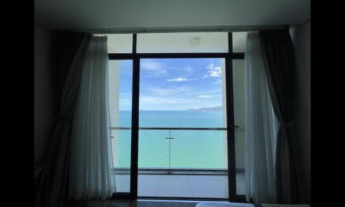 a view of the ocean from a bedroom window at Lenid Ocean View Hotel in Nha Trang
