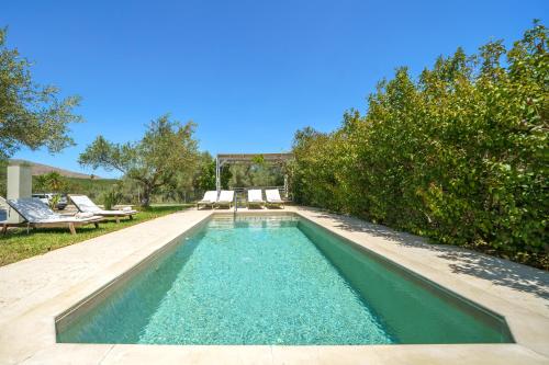 a swimming pool in the middle of a yard at Villa Marian with Private Swimming Pool & Jacuzzi in Georgioupolis