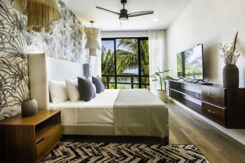 a bedroom with a bed and a dresser and a window at Beachfront Hotel La Palapa - Adults Only in Holbox Island