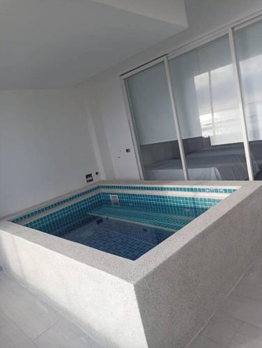 a large swimming pool in a building with at 202 Urban Beach in Lurín