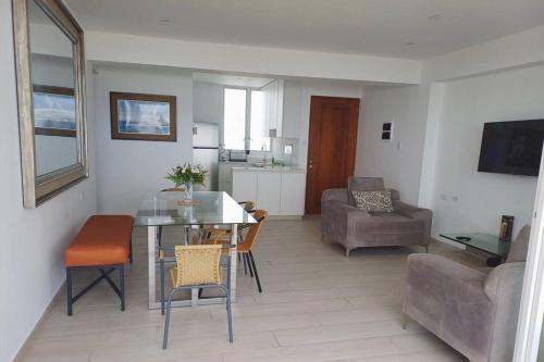 a living room with a table and chairs and a couch at 202 Urban Beach in Lurín