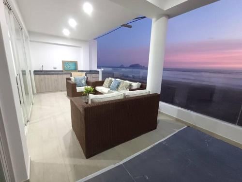a living room with a couch and a large window at 202 Urban Beach in Lurín