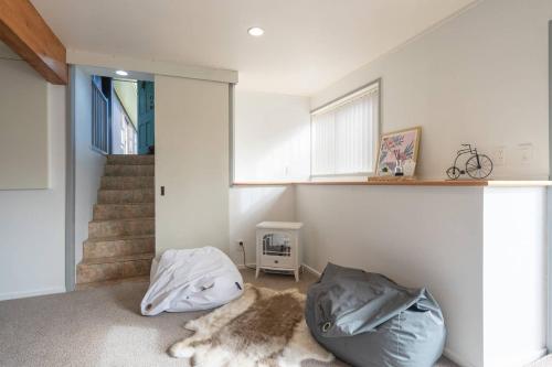 a living room with a bean bag chair and stairs at Foley Retreat in Dairy Flat