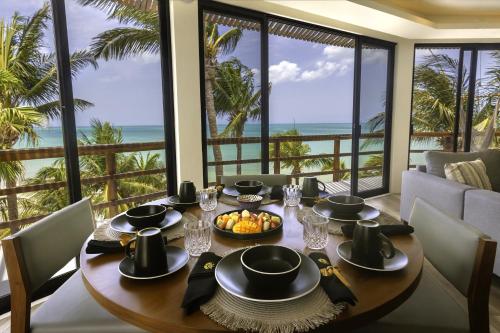 a dining room with a table with a view of the ocean at Beachfront Hotel La Palapa - Adults Only in Holbox Island