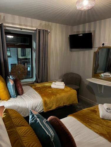 a hotel room with two beds and a window at Woodquay House in Galway