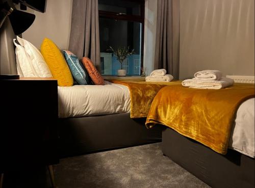 a bedroom with two beds with towels on them at Woodquay House in Galway