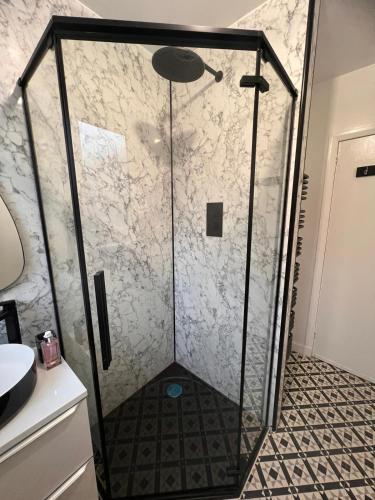 a shower with a glass door in a bathroom at Shared House in Inverness in Inverness
