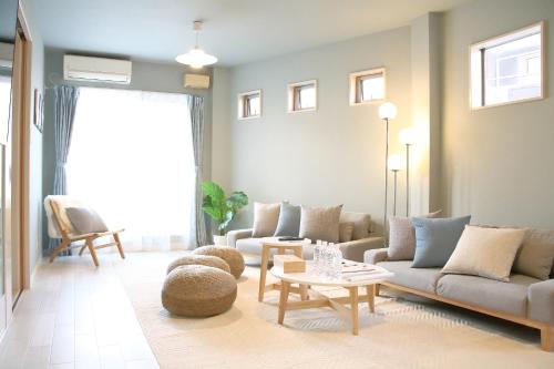 a living room with a couch and a table at Casa Stella 3 Sagittarius by Liaison in Osaka