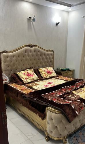 a bed in a room with a large bed with pillows at Bahria town karachi in Karachi