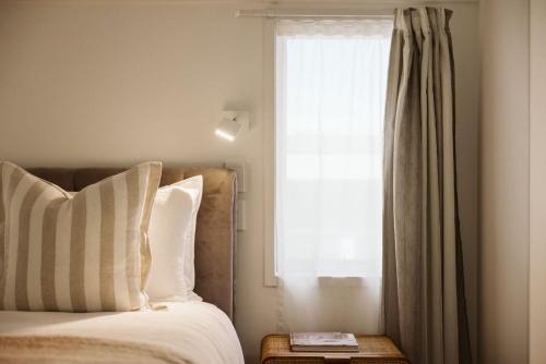 a bedroom with a bed and a window at Seaside Bliss Your Coastal Haven in Mount Maunganui