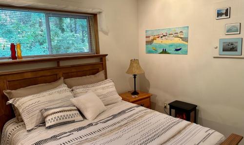 a bedroom with a large bed with a window at Gabriola Island B&B By The Sea in Gabriola