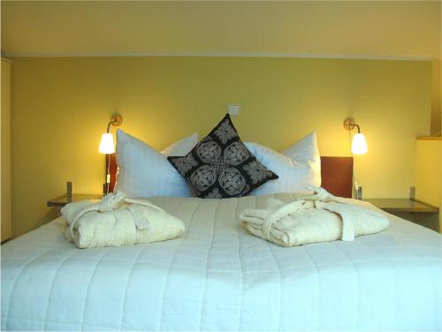 a large white bed with two towels on it at Eisvogel Classic 302 in Granzow