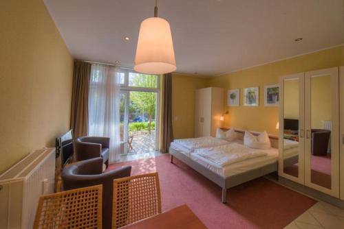 a bedroom with a bed and a large window at Strandläufer 111 in Granzow