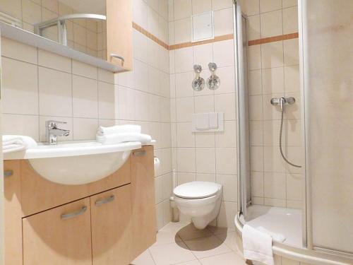 a bathroom with a sink and a toilet and a shower at Strandläufer Classic 108 in Granzow