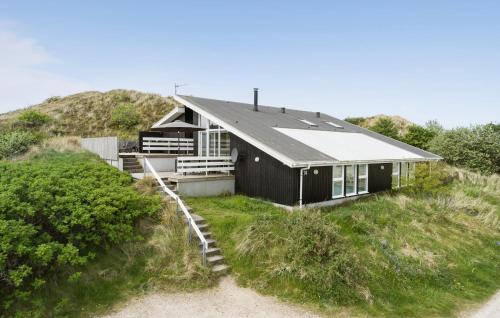 HavrvigにあるNice Home In Hvide Sande With Saunaの丘の上に座る黒家