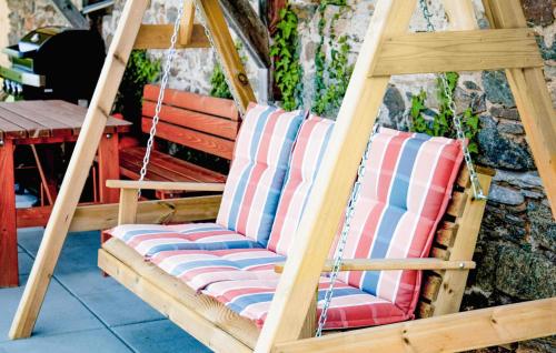 a porch swing with red white and blue striped cushions at Ferienhaus In Eibiswald in Eibiswald