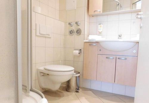 a small bathroom with a toilet and a sink at Schneeeule 223 in Granzow