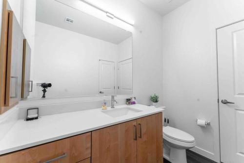 a bathroom with a sink and a toilet and a mirror at Gateway to Old Town Scottsdale King 1 BR & Balcony in Scottsdale