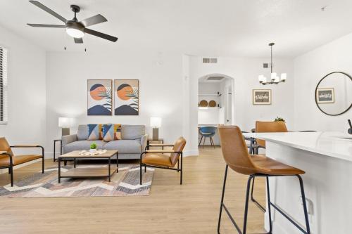 a living room with a couch and a table at CozySuites Glendale by the stadium with pool 13 in Glendale