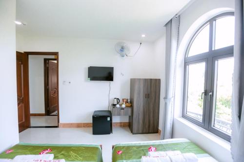 ALEX HOTEL AND SPA في An Bàn: غرفة بيضاء مع سرير ونافذة