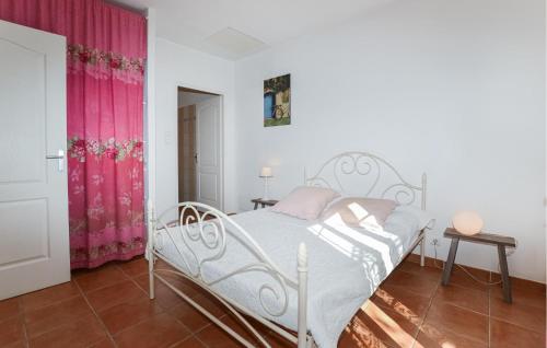 a bedroom with a white bed and pink curtains at Cozy Home In Piscia Rossa With House A Panoramic View in Afa