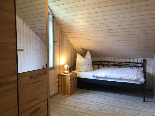 a small bedroom with a bed in a attic at Seeschwalbe Classic 226 in Mirow