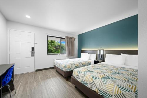 a hotel room with two beds and a window at Motel 6-Monterey, CA in Monterey
