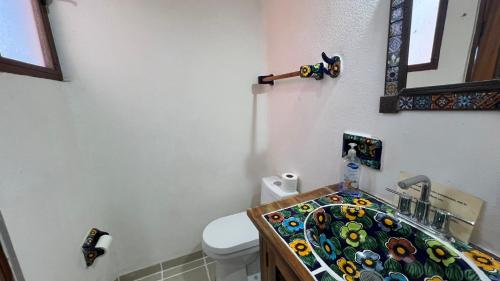 a bathroom with a sink with a stained glass counter top at Villas Chulavista in Sayulita