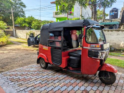 a small red car parked on a brick road at Villa 163 in Negombo
