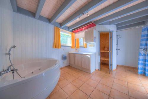 a large bathroom with a tub and a sink at Wildgans Classic 252 in Mirow