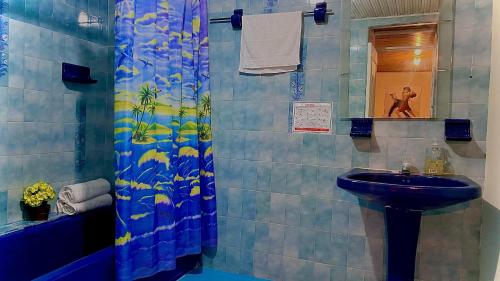 La salle de bains est pourvue d'un lavabo et d'une douche. dans l'établissement Hospedaje Campestre Araucarias, à Santa Rosa de Cabal