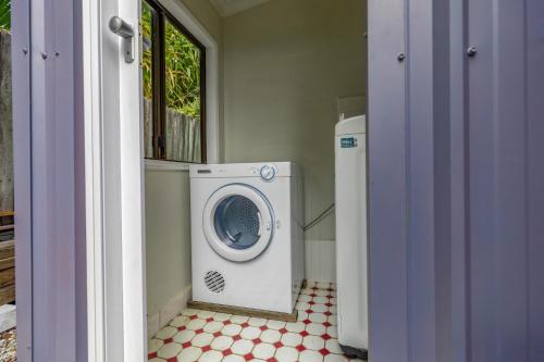 a laundry room with a washing machine in a room at The Little Blue Shack - Quaint Granny Flat in Bli Bli