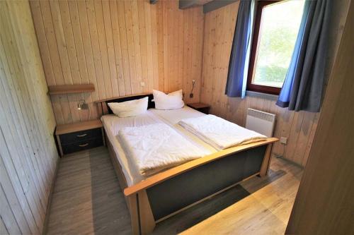 a small bed in a small room with a window at Wildgans 5A in Mirow