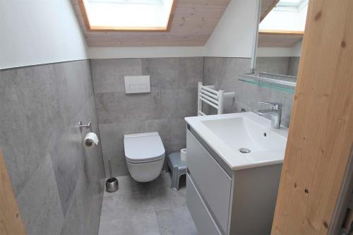 a bathroom with a white toilet and a sink at Wildgans 128 in Mirow