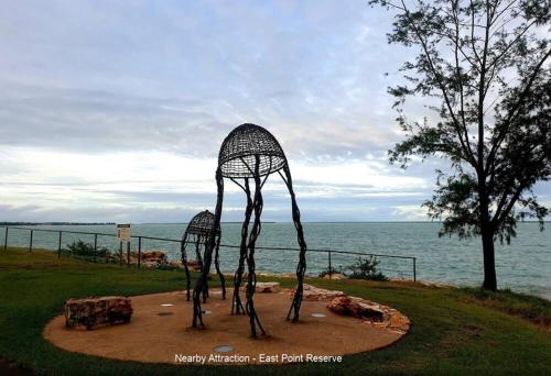 two metal sculptures of cows in a field next to the water at Zenhouse Worker Accom-Trailer - Storage - Pets in Nightcliff