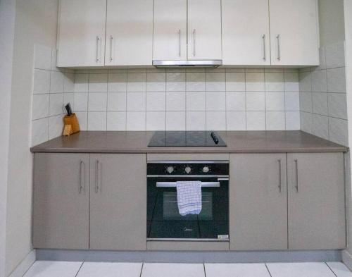 a kitchen with an oven with a towel on it at Zenhouse Worker Accom-Trailer - Storage - Pets in Nightcliff